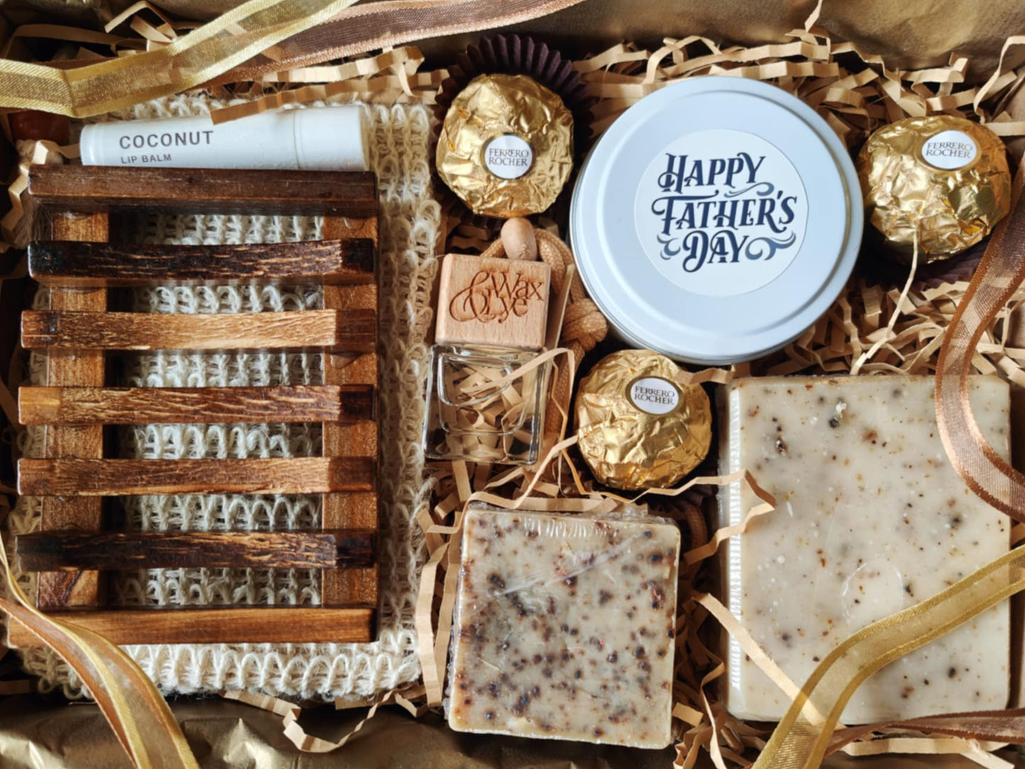 Gift basket with soap, chocolates, and a candle labeled 'Happy Father's Day' on a textured surface.